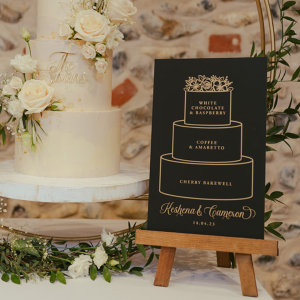 Black and gold acrylic wedding cake sign