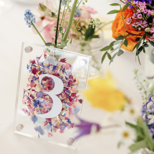 Colourful, flower filled wedding table number